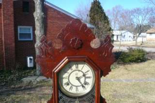  Victorian Shelf Clock that features a raised decorative oak design 