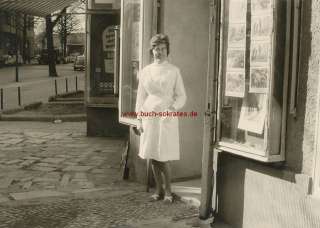 Foto Frau / Apothekerin im weißen Kittel vor Geschäft / Apotheke (ca 