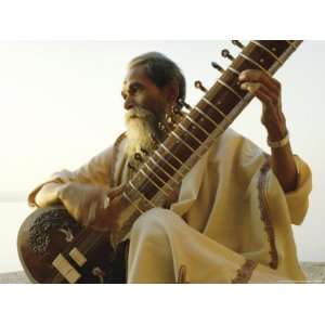  Elderly Man Playing a Sitar by the Ganges River, Varanasi 